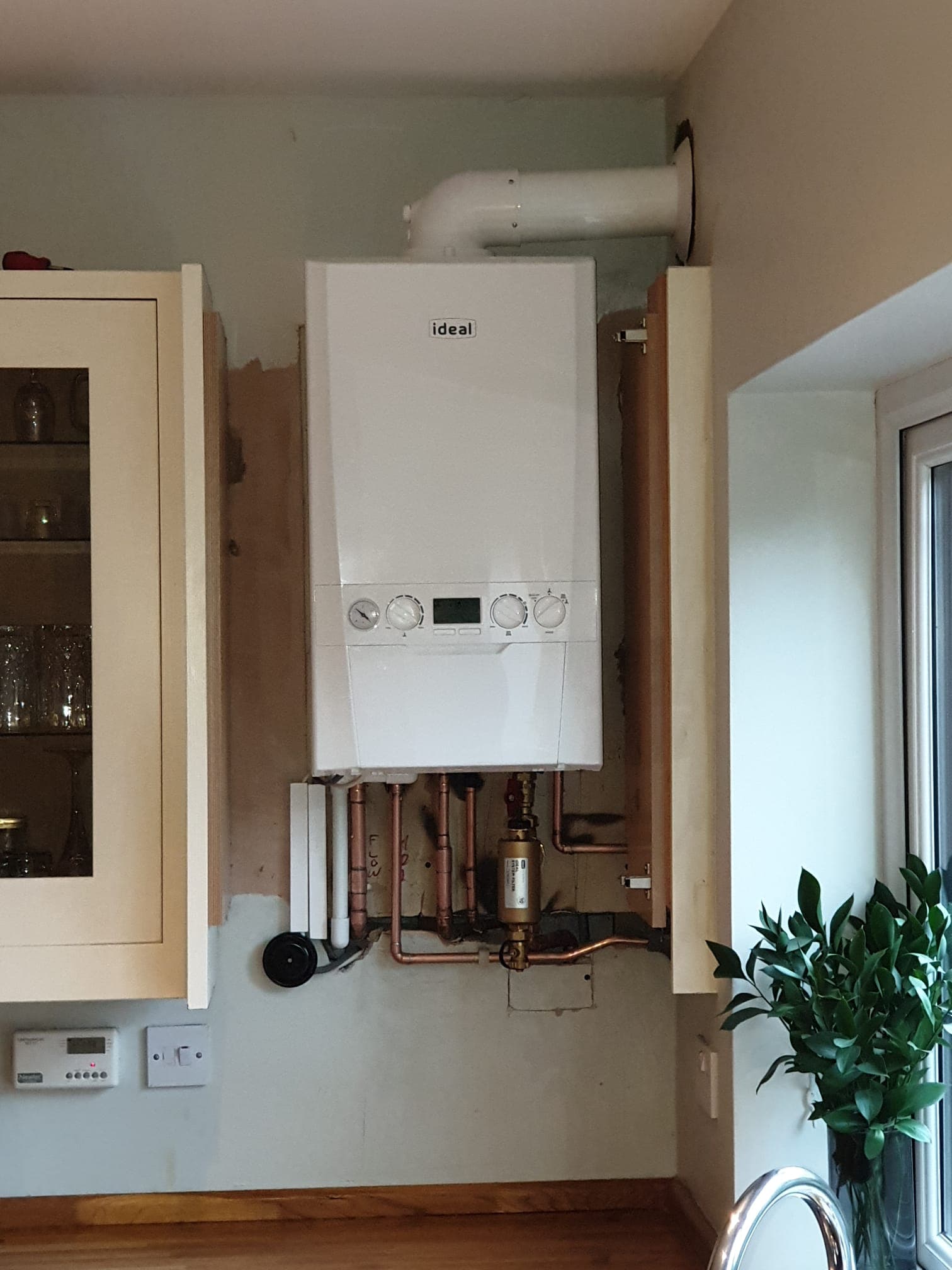 New Ideal combi boiler fitted on a kitchen wall by DJ's Plumbing